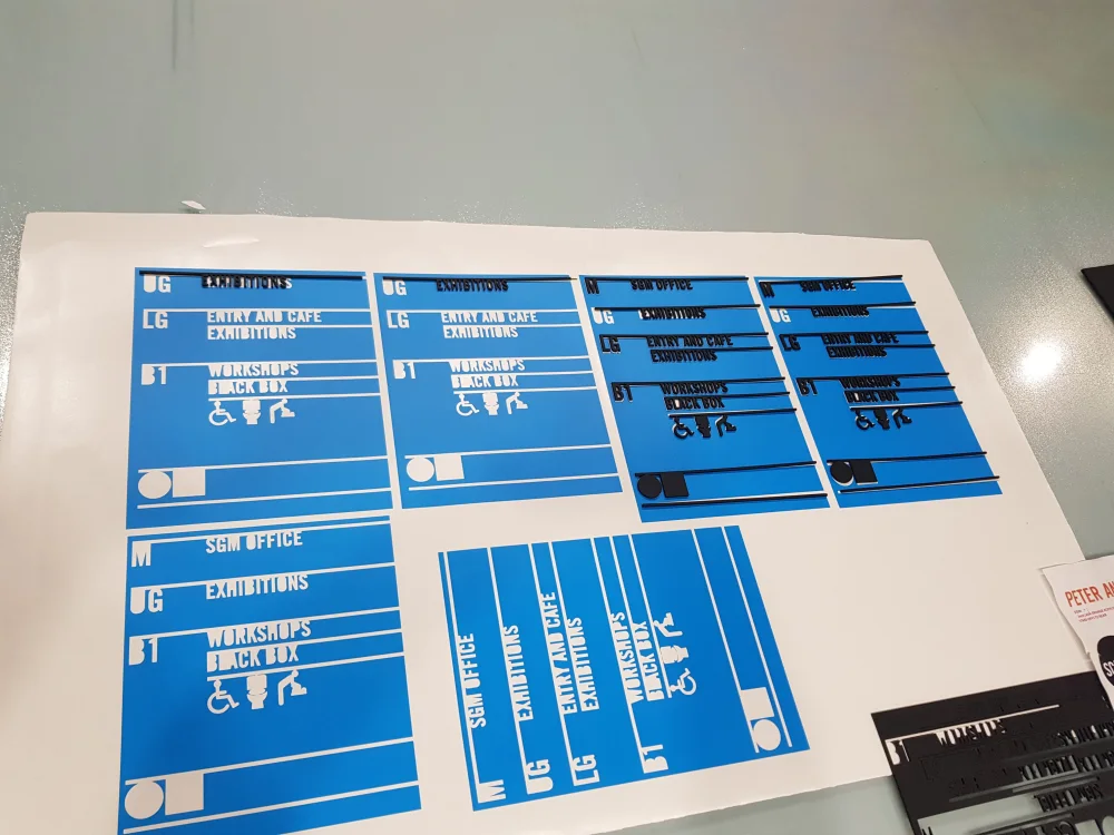 Wayfinding lettering being prepared in a signage workshop